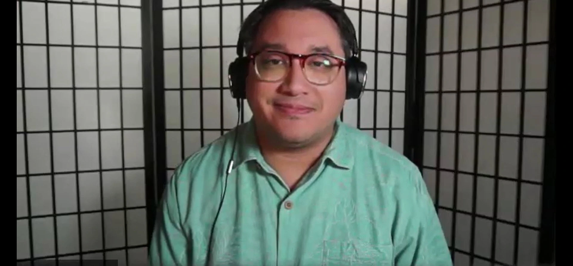 Jacob Martinez in front of a black and white folding screen